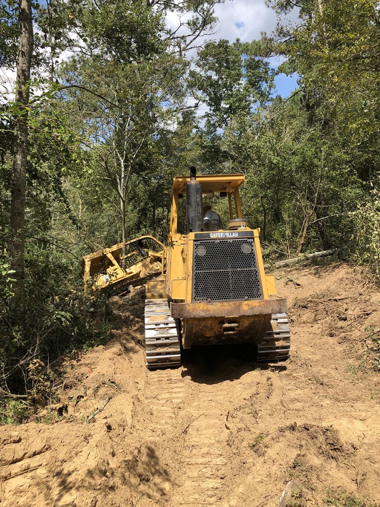 This was quite a drama. A 26-ton bulldozer making a road from the main property down to the Duck River nearly tipped into the river. Here a 26-ton loader pulls the dozer out.